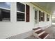 Charming home featuring a welcoming front door with decorative glass and red shutters adding a touch of color at 472 Trout Ln, Oldsmar, FL 34677