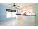 Bright kitchen features white cabinets and an island with bar seating, perfect for casual dining at 472 Trout Ln, Oldsmar, FL 34677