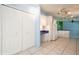 Kitchen area with built in desk, tile flooring, and white cabinets at 472 Trout Ln, Oldsmar, FL 34677