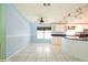 Bright kitchen features white cabinets and an island with bar seating, perfect for casual dining at 472 Trout Ln, Oldsmar, FL 34677
