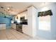 Well-lit kitchen featuring stainless steel appliances, white cabinets, and tile flooring at 472 Trout Ln, Oldsmar, FL 34677