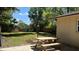 Well-maintained backyard featuring a picnic table, grassy area and privacy fence at 4824 16Th St, Zephyrhills, FL 33542