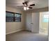 Bedroom with carpet, ceiling fan, window with blinds, and ensuite bathroom at 4824 16Th St, Zephyrhills, FL 33542