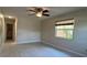 Bedroom featuring tile floors, a ceiling fan, and a window with a view to the outdoors at 4824 16Th St, Zephyrhills, FL 33542