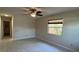 Bedroom with wood look tile flooring, ceiling fan, and window at 4824 16Th St, Zephyrhills, FL 33542