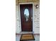 Elegant front door with decorative glass, a 'Welcome' mat, and a modern electronic lock at 4824 16Th St, Zephyrhills, FL 33542