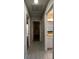 Hallway with wood look tile flooring and multiple doorways leading to various rooms at 4824 16Th St, Zephyrhills, FL 33542