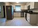 Modern kitchen with white cabinets, stainless steel appliances, and tile floors at 4824 16Th St, Zephyrhills, FL 33542