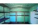 Interior of metal storage shed with wooden shelving units at 4824 16Th St, Zephyrhills, FL 33542