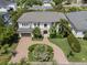 Aerial shot of a grand two-story home with circular driveway, lush landscaping, and manicured lawn at 5025 W Homer Ave, Tampa, FL 33629