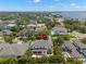 Aerial view of the property with a lush green lawn, tropical landscaping, and water views at 5025 W Homer Ave, Tampa, FL 33629