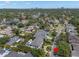 Neighborhood view with the home's location, surrounded by mature trees and lush tropical landscaping at 5025 W Homer Ave, Tampa, FL 33629