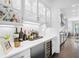 A bar area features wine storage, beverage center, and white herringbone tile backsplash at 5025 W Homer Ave, Tampa, FL 33629