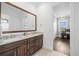 Bathroom boasting a double vanity with light countertops and dark wood cabinets at 5025 W Homer Ave, Tampa, FL 33629