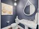 Powder room with blue wallpaper and decorative mirror at 5025 W Homer Ave, Tampa, FL 33629