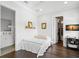 Bright bedroom featuring a bed and bathroom and walk-in closet in the doorway at 5025 W Homer Ave, Tampa, FL 33629