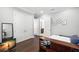 Bedroom with hardwood floors, closet access, and decorative artwork at 5025 W Homer Ave, Tampa, FL 33629