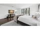 Primary bedroom with hardwood floors, neutral color palette, decorative seating, and large windows at 5025 W Homer Ave, Tampa, FL 33629