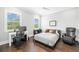 Well-lit bedroom featuring hardwood floors, desk and chair, and a ceiling fan at 5025 W Homer Ave, Tampa, FL 33629