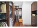 Walk-in closet with custom shelving and wooden cabinets for optimal storage and organization at 5025 W Homer Ave, Tampa, FL 33629