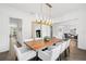 Elegant dining room featuring a modern chandelier, hardwood floors, and an open layout at 5025 W Homer Ave, Tampa, FL 33629