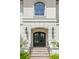 Charming entryway showcasing a decorative door, detailed stone columns, and lush landscaping at 5025 W Homer Ave, Tampa, FL 33629