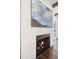 Fireplace with large artwork on white stacked stone wall and hardwood floors at 5025 W Homer Ave, Tampa, FL 33629