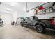 Spacious garage with high ceilings and storage featuring a black pickup truck at 5025 W Homer Ave, Tampa, FL 33629