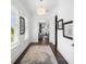 Hallway with hardwood floors, bright white walls, and an open doorway to the primary bedroom suite at 5025 W Homer Ave, Tampa, FL 33629