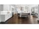 Bright eat-in kitchen with white cabinetry, stainless steel appliances, and hardwood floors at 5025 W Homer Ave, Tampa, FL 33629