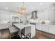 Bright kitchen with stainless steel appliances, white cabinetry and large central island at 5025 W Homer Ave, Tampa, FL 33629