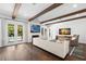 Bright living room features wooden beams, fireplace, and access to the outdoor pool area at 5025 W Homer Ave, Tampa, FL 33629