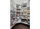Well stocked walk-in pantry with floor to ceiling white shelving at 5025 W Homer Ave, Tampa, FL 33629