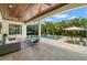 Covered patio featuring comfortable seating, a view of the pool, and lush landscaping at 5025 W Homer Ave, Tampa, FL 33629