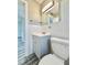 Updated bathroom features a white vanity, tiled walls, and modern fixtures at 5043 Osprey Ln, New Port Richey, FL 34652