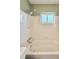 Bathroom featuring a tiled shower and tub, a shower head and updated fixtures at 5043 Osprey Ln, New Port Richey, FL 34652