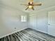Bedroom featuring new windows, wood-look floors, a ceiling fan, and closet at 5043 Osprey Ln, New Port Richey, FL 34652