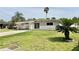 Single-story home with a carport and landscaped yard; a cozy suburban retreat at 5043 Osprey Ln, New Port Richey, FL 34652