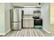 Updated kitchen with stainless steel fridge and oven, and white cabinets at 5043 Osprey Ln, New Port Richey, FL 34652