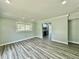 Inviting living room featuring new flooring, updated paint, and recessed lighting at 5043 Osprey Ln, New Port Richey, FL 34652
