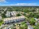 A high angle, aerial view of the residences featuring covered parking, landscaping and mature trees surrounding the area at 5150 10Th N Ave # 302, St Petersburg, FL 33710