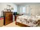 Cozy bedroom featuring a floral bedspread, wooden dresser, and a bright window at 5150 10Th N Ave # 302, St Petersburg, FL 33710