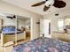 Spacious bedroom with ceiling fan, mirror closet doors, and neutral decor at 5150 10Th N Ave # 302, St Petersburg, FL 33710