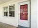 Close up of the condo entrance, featuring a modern door with white frame and red accents at 5150 10Th N Ave # 302, St Petersburg, FL 33710