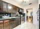 Kitchen featuring dark wood cabinets, stainless steel oven, and a view into an adjacent living space at 5150 10Th N Ave # 302, St Petersburg, FL 33710