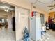 Spacious room with tile floors and a sliding door, featuring a freezer and view into the kitchen at 5150 10Th N Ave # 302, St Petersburg, FL 33710