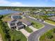 Aerial view of houses with a playground, community center, fountain, and pond in the distance at 5938 164Th E Ave, Parrish, FL 34219