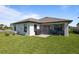 Lovely backyard featuring a screened-in lanai perfect for outdoor dining and a well-maintained lawn at 5938 164Th E Ave, Parrish, FL 34219