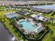 Aerial view of community center, pool, tennis courts, and playground with surrounding landscape at 5938 164Th E Ave, Parrish, FL 34219
