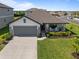 Beautiful single Gathering home with a large driveway, manicured lawn and attractive landscaping at 5938 164Th E Ave, Parrish, FL 34219